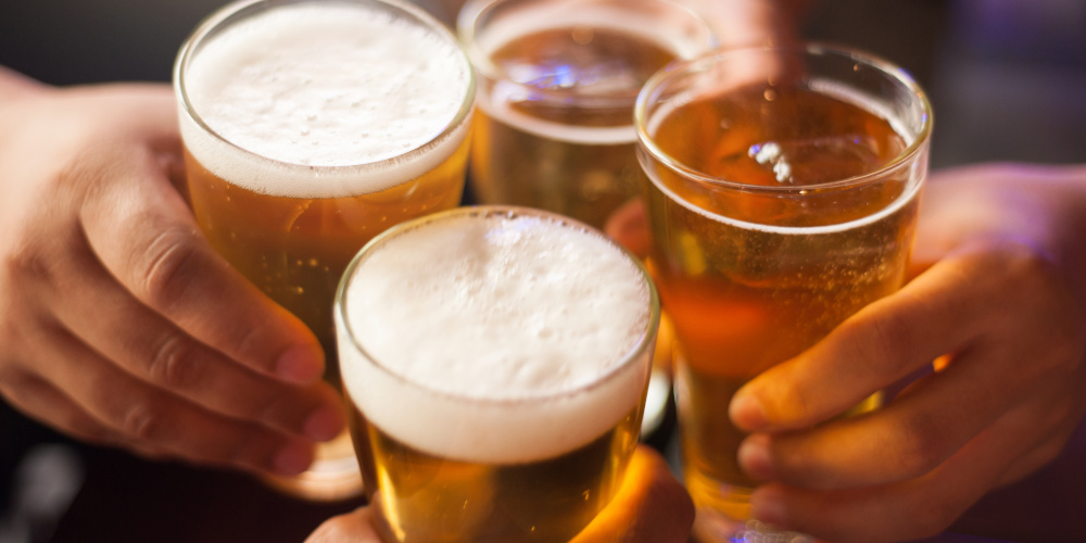 Cheers! Clink glasses. Close-up shots of hands holding beer glas